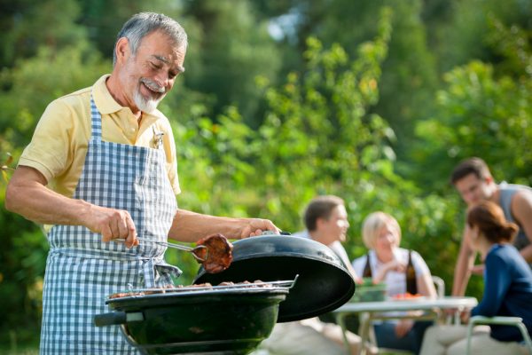 Family having a barbecue party in their garden in summer