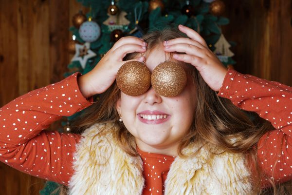 Girl Excited for Holidays with Oranments