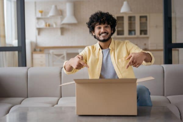 Man Points To Cardboard Box